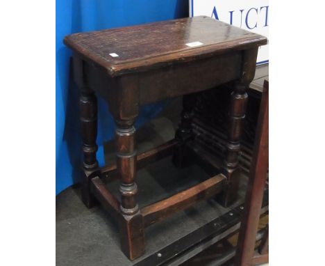 Antique oak joint stool having quadrant mould edge to the top, on ring turned supports and cross-stretcher 