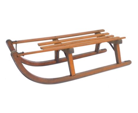 A 20thC sledge, with slatted top, 93cm long. 