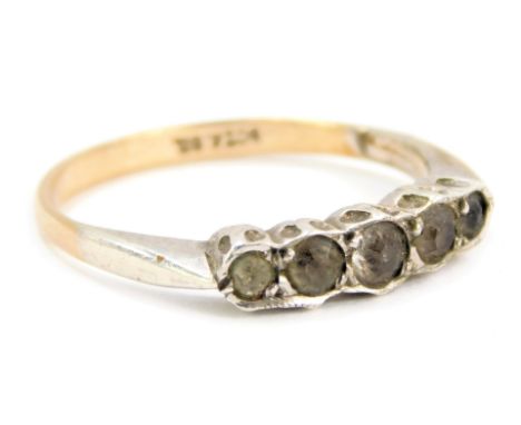 A five stone dress ring, set with five imitation diamonds in a rub over white metal setting on a yellow metal band, stamped 9