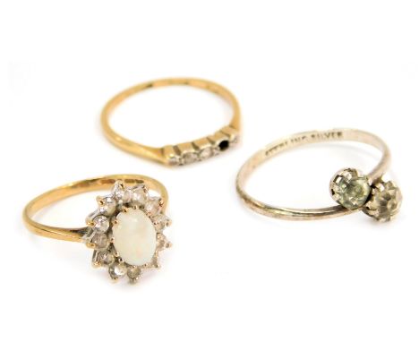 Three dress rings, comprising a 9ct gold imitation opal and diamond cluster ring, an 18ct gold and plat diamond five stone dr