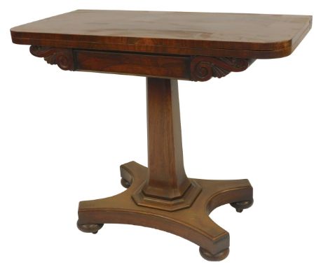 A Victorian rosewood card table, the foldover top with green baize interior, scroll carved apron on a tapering column, on qua