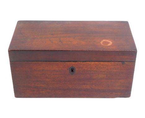 A Georgian mahogany tea caddy, of rectangular form with lion head ring handles to each side, the hinged lid enclosing three l