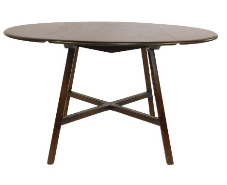 An Ercol dark stained elm oval drop leaf dining table, on channelled legs, 112cm wide.