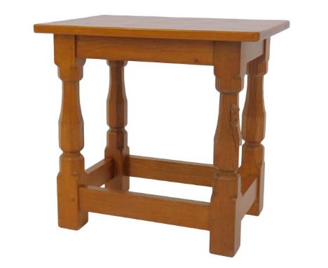 A Robert Mouseman Thompson of Kilburn oak stool, the rectangular top raised on four square legs, one carved with mouse, unite