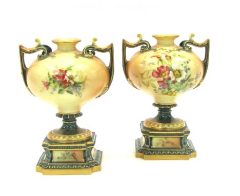 A pair of mid 20thC Royal Worcester blush porcelain twin-handled vases, each of compressed globular form, decorated with hand
