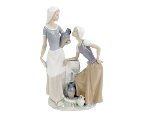 A Nao porcelain figure group, modelled as two female water carriers beside a pump, printed marks, 42cm high, boxed.