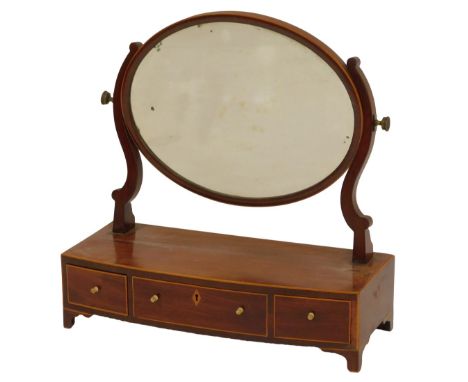 A 19thC mahogany and boxwood line inlaid swing frame mirror, the oval mirror on scrolling supports, the bow fronted base with
