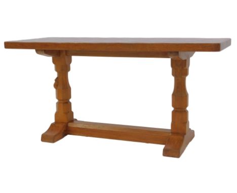 A Robert Mouseman Thompson of Kilburn oak coffee table, the rectangular top raised on two carved columns, one with mouse, on 