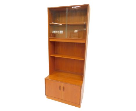 A G-Plan teak display cabinet, the top with two sliding doors enclosing shelf, with two further shelves, the base with two cu