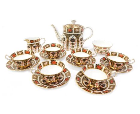 A Royal Crown Derby porcelain tea service decorated in the Old Imari pattern, comprising teapot, 19cm high, six teacups and s