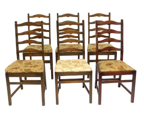 A set of six Ercol dark elm ladder back chairs, with removable seats, bearing label. The upholstery in this lot does not comp