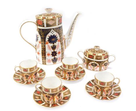 A Royal Crown Derby porcelain coffee service decorated in the Old Imari pattern, comprising a coffee pot, 22cm high, four cof