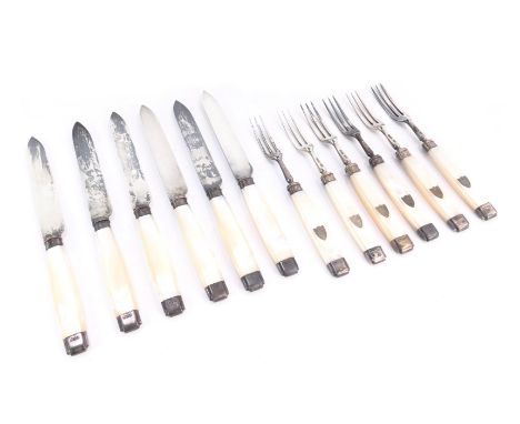 A set of six Victorian silver and mother of pearl handled fruit knives and forks, the handles with vacant silver shield, Harr