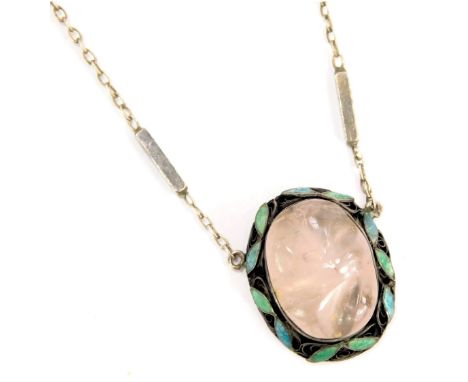 A 1950s/60s pendant and chain, the oval pendant with blue and green leaf enamel, with central carved rose quartz, on a white 