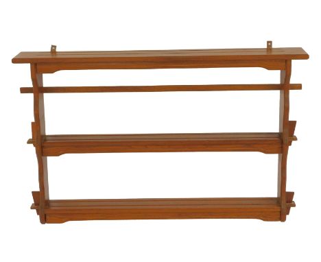 A 20thC oak three tier hanging wall shelf, 57cm high, 87.5cm wide.