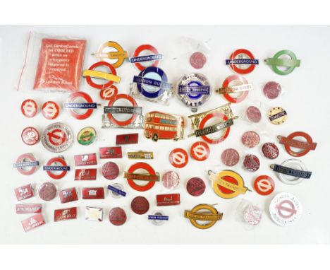 A good collection of London Underground railway badges to include enamel cap badges and a silver hallmarked example