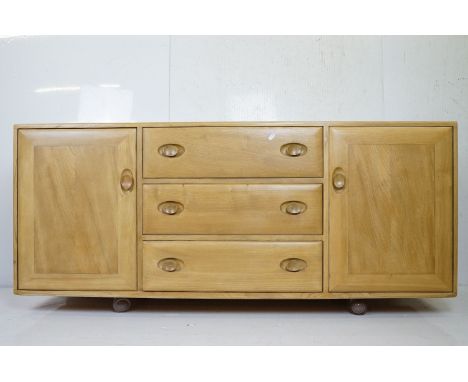 Ercol Pale Elm Windsor 455 Sideboard with central bank of three drawers flanked either side by cupboards, 156cm long x 44cm d