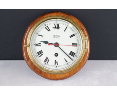 Smiths Astral brass bulkhead nautical ships clock, with bevelled glass front, the cream dial with black Roman numerals and po