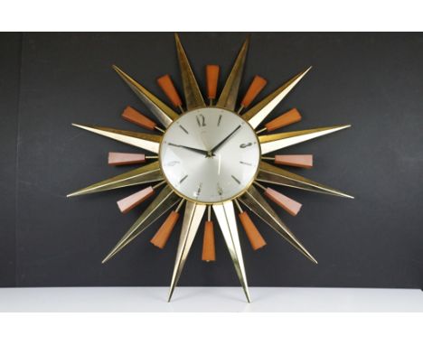 Mid 20th C Metamec brass &amp; teak sunburst wall clock, the silvered dial with applied Arabic numerals. Approx 59cm wide 