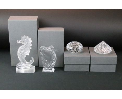 Four Waterford crystal boxed cut glass paperweights and ornaments to include a sea horse ornament, harp, prism and paper weig