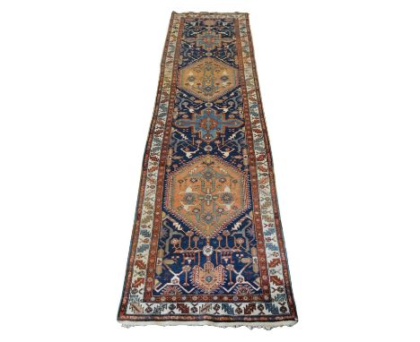 South Caucasian Garabagh runner, circa 1900, cobalt blue field with repeating medallions in coral, triple banded border with 
