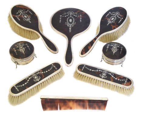 A George V silver and tortoiseshell dressing set, comprising mirror, four brushes, comb and two trinket boxes, E S Barnsley &