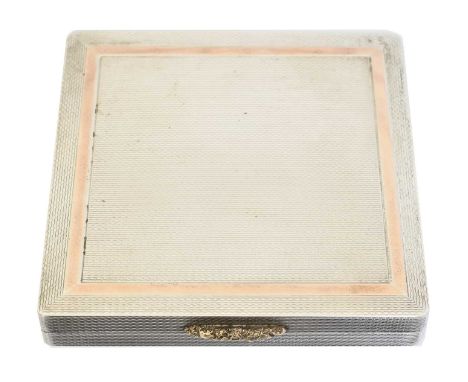 An Elizabeth II silver compact, engine turned with silver gilt decoration and interior, hallmarks for W H Manton Ltd., Birmin