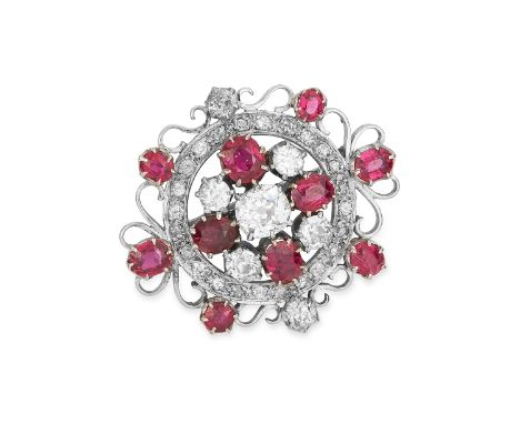 ANTIQUE DIAMOND AND RUBY BROOCH set with a principal old cut diamond of 1.55 carats, accented by round and oval cut rubies an