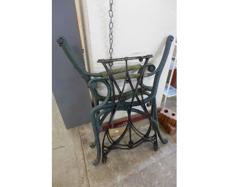 A pair of cast iron bench ends and a pair of wrought table legs