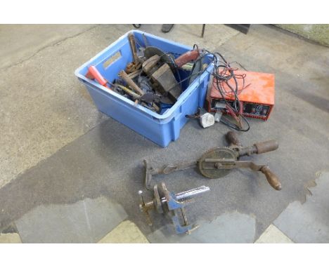 A box of tools including clamps, vices, hand drill, etc.
