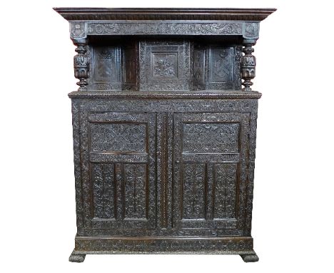 An impressive 17th Century style oak armorial court cupboard, the frieze dated 1696 and initialled WL and MS flanked by drago