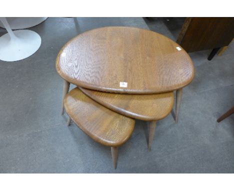 An Ercol pebble shaped nest of tables