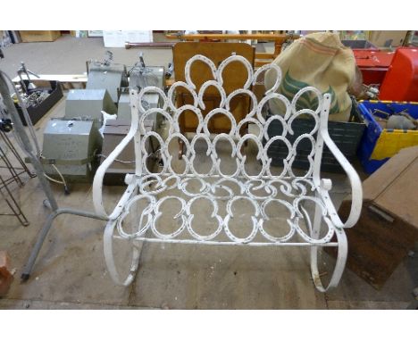 A wrought iron horse shoe garden bench