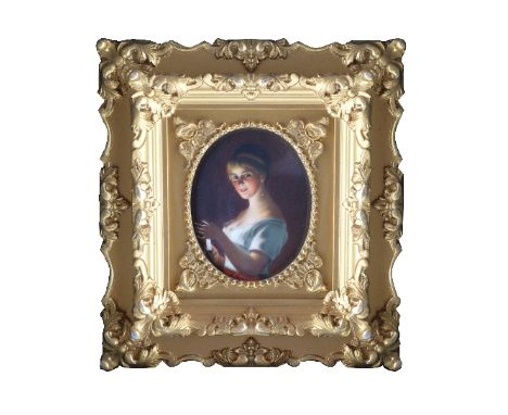 An early 19th Century portrait miniature of a lady, oval quarter length, on porcelain, 8.5 x 7cms, gilt frame