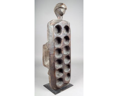 A West African Mancala board with a carved head terminal and a central block support 68cm long.  Provenance Ian Auld London. 