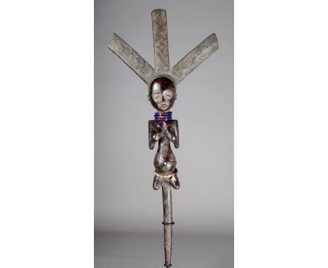 A Luba bow stand D.R.Congo carved a kneeling female figure with body scarifications and supporting her breasts and with a tri