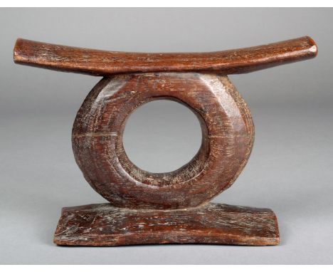 A Fiji headrest carved wood with a curved top bar above a circle support and rectangular base 17cm high.  Provenance Ian Auld