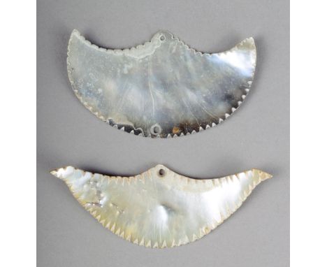 Two Solomon Island mother of pearl ornaments of gorget form with serrated edges 7cm and 7.7cm wide. (2)