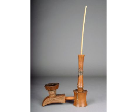 A Shona carved wood pipe Zimbabwe of abstract form with zig zag carving applied brass wire links and plaited porcupine quill 