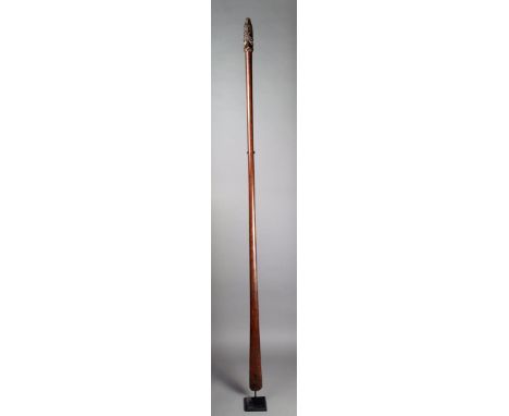 A Maori taiaha of long spatulate form with a carved Janus head terminal with mother of pearl eyes and with carved tongue 198c