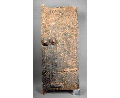 A Dogon door Mali constructed from two boards one carved with two breasts 133cm high 52.5cm wide.  Provenance Ian Auld London