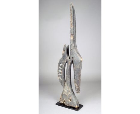 A Bambara antelope headdress Chi Wara Mali with a tapering base one side with skin patch 72cm high on a stand. 