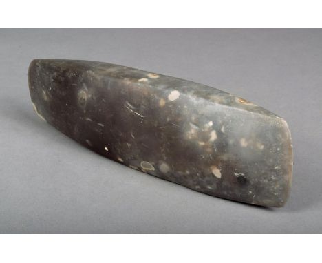 A Neolithic adze blade of rectangular form with pointed ends 28.5cm long. 