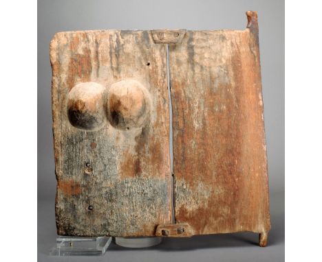 A Dogon grain door Mali constructed of two panels one carved with a pair of breasts 42cm wide.  Provenance Ian Auld London.
