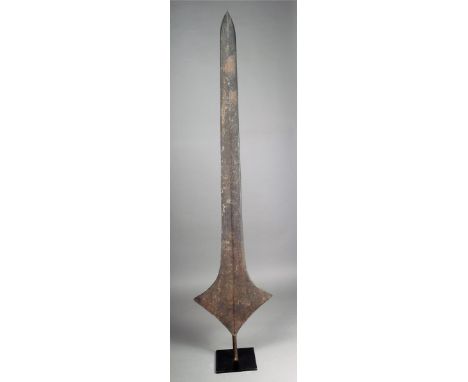 A Topoke iron currency blade D R Congo with linear decoration to opposing sides 170cm high on a stand. (2)