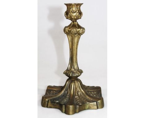 A George II style gilt metal candlestick, probably early 20thC with inverted floral stem, stylised campana dish holder and fl