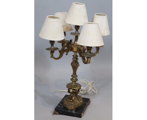 A 20thC rococo style four branch table lamp candelabrum, with modern fittings, shaped inverted stem, bombé foot and marble fi
