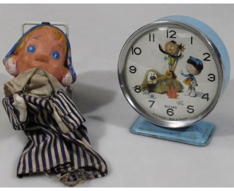 A mid 20thC Bayard Magic Roundabout alarm clock, with articulated 10cm dia. dial in blue trim, and a Andy Pandy glove puppet.