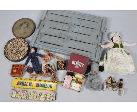 A mid 20thC tin plate and wooden ice hockey game, with articulated pieces on wooden board with moving parts, 70cm wide, vario