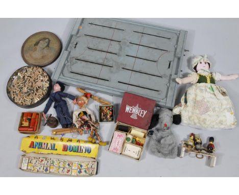 A mid 20thC tin plate and wooden ice hockey game, with articulated pieces on wooden board with moving parts, 70cm wide, vario